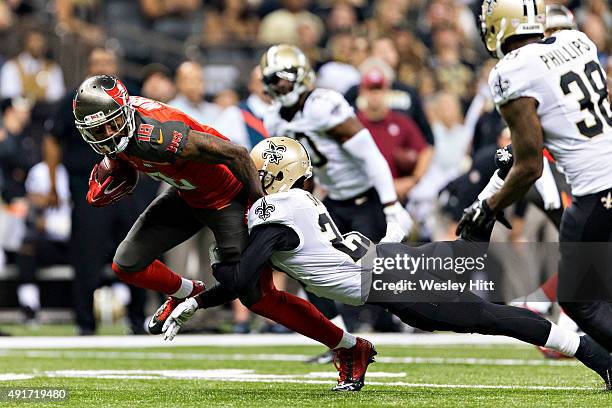 Louis Murphy of the Tampa Bay Buccaneers is tackled by Damian Swann of the New Orleans Saints at Mercedes-Benz Superdome on September 20, 2015 in New...