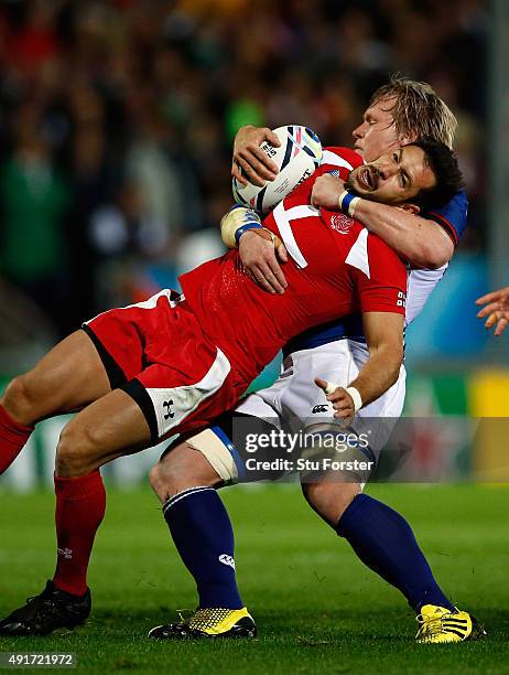 Renaldo Bothma of Namibia pulls down Lasha Malaguradze of Georgia and is yellow carded during the 2015 Rugby World Cup Pool C match between Namibia...