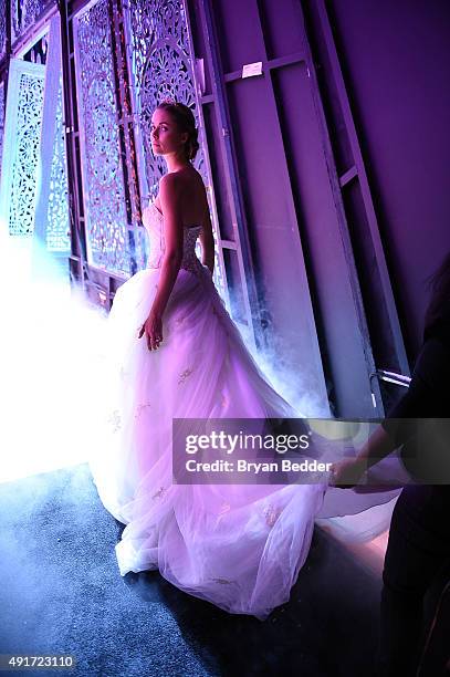 Model prepares backstage during 2016 Alfred Angelo Disney Fairy Tale Weddings Bridal Collection fashion show debut at New Amsterdam Theatre on...