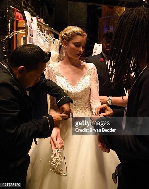 Model prepares backstage during 2016 Alfred Angelo Disney Fairy Tale Weddings Bridal Collection fashion show debut at New Amsterdam Theatre on...