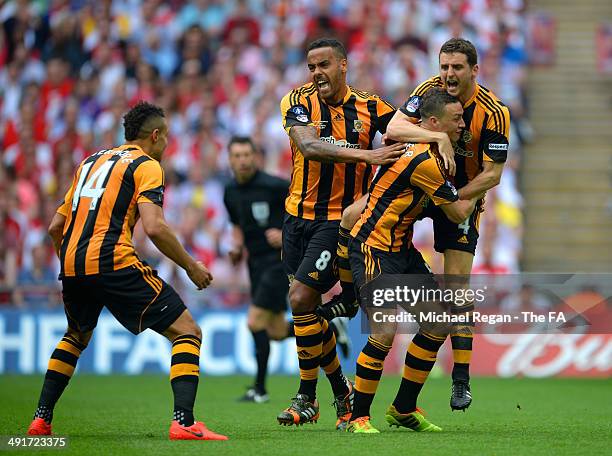 James Chester of Hull City celebrates with team-mates Alex Bruce and Tom Huddlestone after scoring the opening goal during the FA Cup with Budweiser...