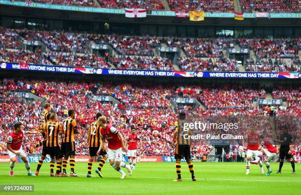 Santi Cazorla of Arsenal scores their first goal from a free kick during the FA Cup with Budweiser Final match between Arsenal and Hull City at...