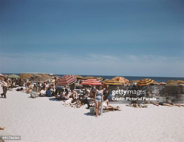 Holidaymakers on Jones Beach Island, off the coast of Long Island, New York State, USA, circa 1965.