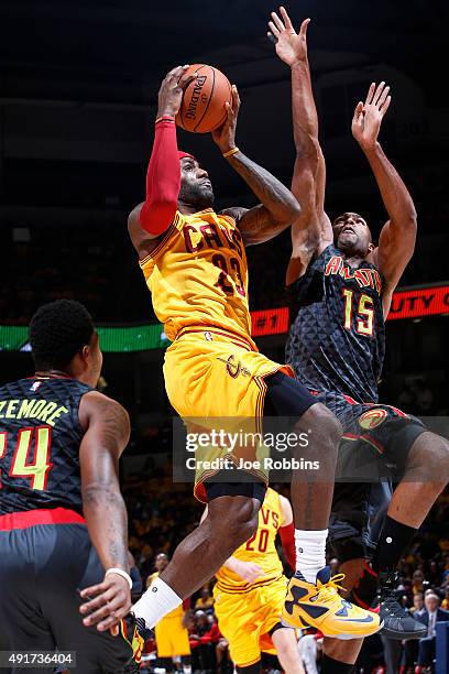 LeBron James of the Cleveland Cavaliers drives to the basket against Al Horford of the Atlanta Hawks in the first half of a preseason game at Cintas...