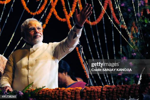 Indian prime minister-elect Narendra Modi waves to supporters after performing a religious ritual at the banks of the River Ganges in Varanasi on May...