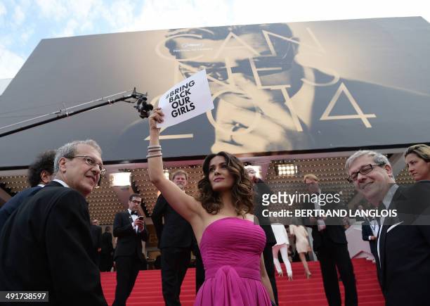 Mexican-US actress and producer Salma Hayek-Pinault holds a cardboard reading "# Bring back our girls", as a sign of support for the kidnapped...