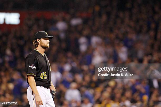 Gerrit Cole of the Pittsburgh Pirates reacts after giving up a two-run home run to Kyle Schwarber of the Chicago Cubs in the third inning during the...