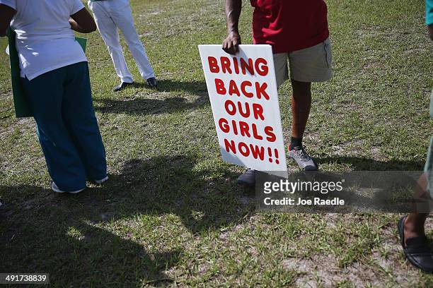 Dan McNeil holds a sign as he joins with others to support the Coalition of Concerned Nigerians in South Florida during a rally to show support for...