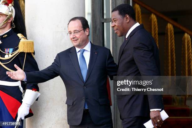 Benin's President Thomas Boni Yayi is escorted by French president Francois Hollande as he leaves the African security summit on May 17 at the Elysee...