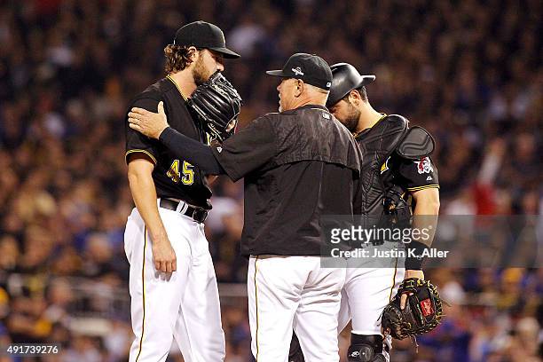 Ray Searage of the Pittsburgh Pirates talks with Gerrit Cole of the Pittsburgh Pirates and Francisco Cervelli of the Pittsburgh Pirates on the...