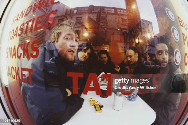 English alternative rock Elbow seen through a cafe window, December 2000. Left to right: singer Guy Garvey, keyboard player Craig Potter, guitarist...