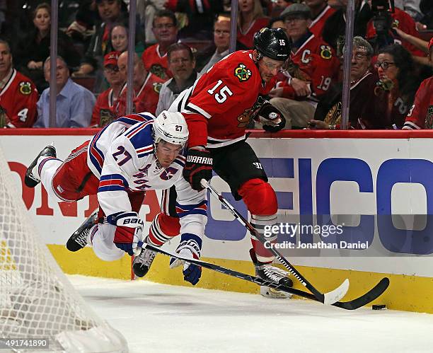 Ryan McDonagh of the New York Rangers go airborne as he battle for the puck with Artem Anisimov of the Chicago Blackhawks during an NHL game at the...