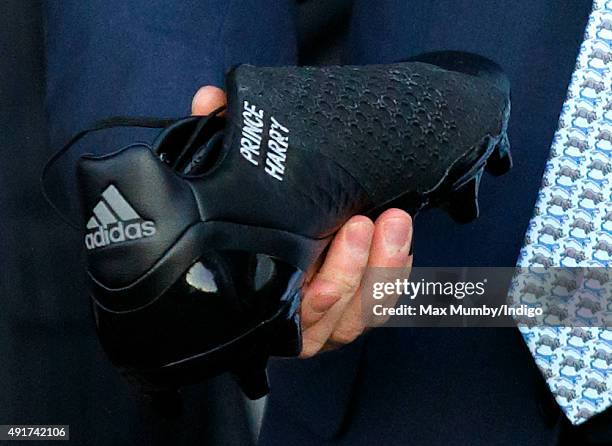 Prince Harry is presented with a pair of rugby boots with his name stitched into them as he visits Paignton Rugby Club to present them with an RFU,...