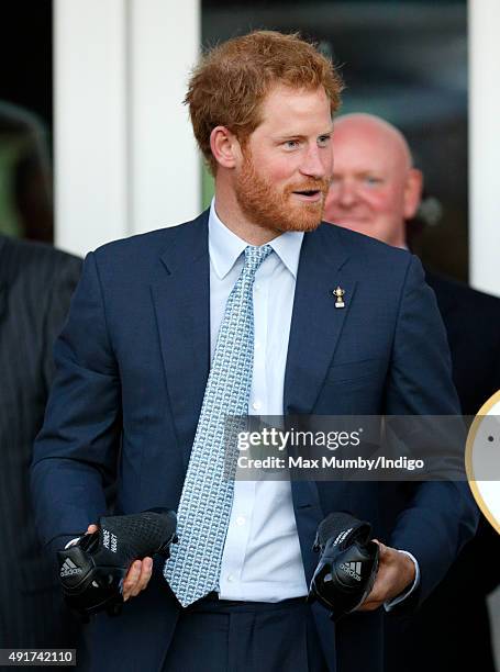 Prince Harry is presented with a pair of rugby boots with his name stitched into them as he visits Paignton Rugby Club to present them with an RFU,...