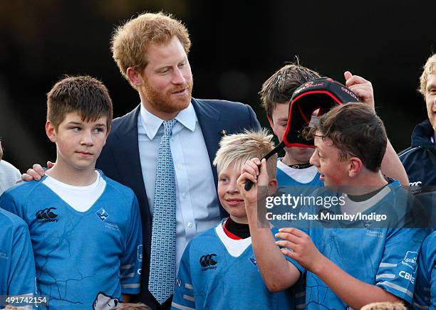 Prince Harry meets young players as he visits Paignton Rugby Club to present them with an RFU, Gold Standard Facilities Award on October 7, 2015 in...