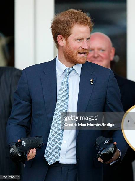 Prince Harry is presented with a pair of rugby boots with his name stitched into them as he visits Paignton Rugby Club to present them with an RFU,...