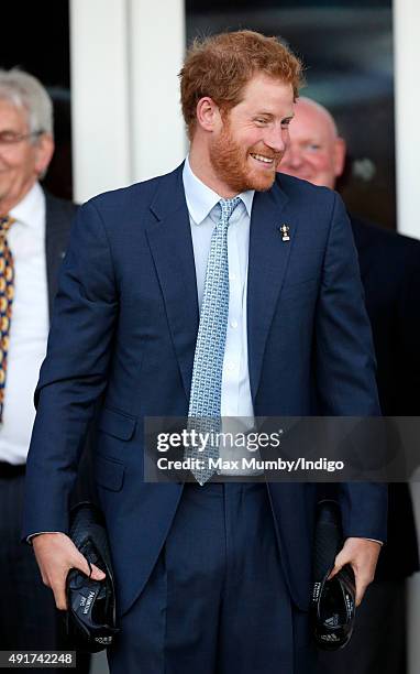 Prince Harry is presented with a pair of rugby boots with his name stitched into them as he visits Paignton Rugby Club to present them with an RFU,...