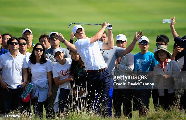 Jordan Spieth of the United States Team hits a shot from the rough on the first hole during the Thursday foursomes matches at The Presidents Cup at...