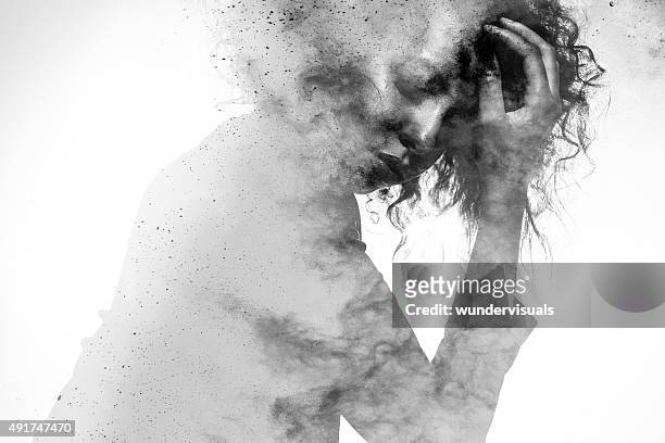 unhappy woman's form double exposed with paint splatter effect - depression sadness stock pictures, royalty-free photos & images