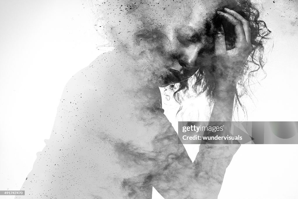 Unhappy woman's form double exposed with paint splatter effect