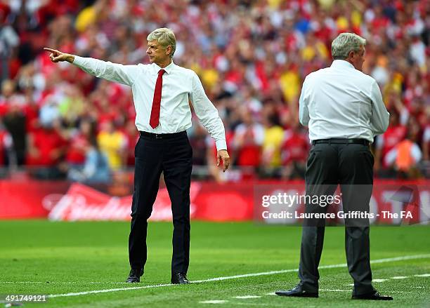 Arsene Wenger, manager of Arsenal reacts on the touchline next to Steve Bruce, manager of Hull City during the FA Cup with Budweiser Final match...