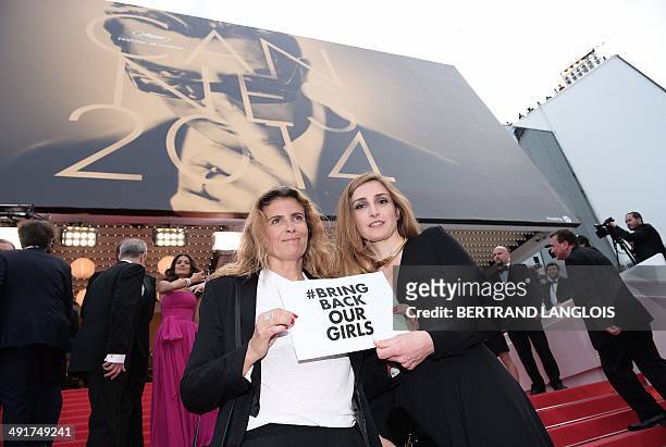 French actress Julie Gayet and French director Lisa Azuelos hold a cardboard reading "# Bring back our girls", as a sign of support for the kidnapped...