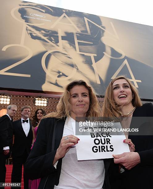 French actress Julie Gayet and French director Lisa Azuelos hold a cardboard reading "# Bring back our girls", as a sign of support for the kidnapped...