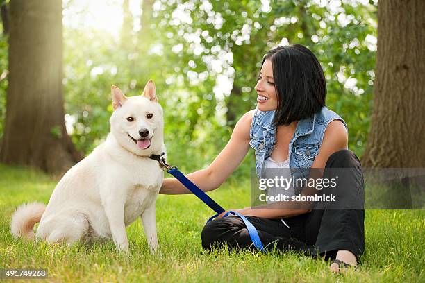 young woman enjoying beautiful day with dog - shiba inu adult stock pictures, royalty-free photos & images