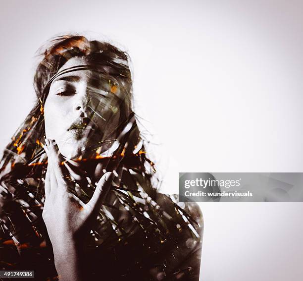 tribal looking woman's silhouette with leaves overlaying the image - bobo tribe stock pictures, royalty-free photos & images