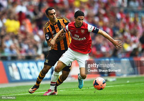 Mikel Arteta of Arsenal evades Ahmed Elmohamady of Hull City during the FA Cup with Budweiser Final match between Arsenal and Hull City at Wembley...