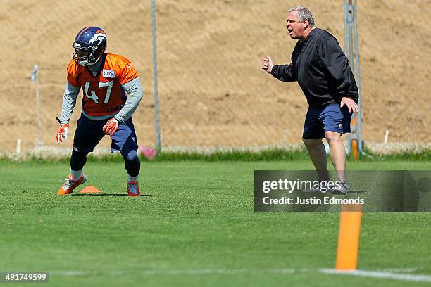 Linebacker Corey Nelson of the Denver Broncos participates in drills with linebackers coach Richard Smith during rookie minicamp at Dove Valley on...