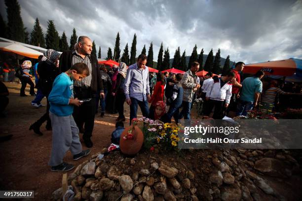 Relatives of a miner read holy Kuran beside his grave following the Soma mining disaster, on May 17, 2014 in Soma, Manisa, Turkey. Manisa Governorate...