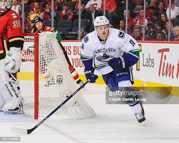 Jared McCann of the Vancouver Canucks skates against the Calgary Flames in the season opener at Scotiabank Saddledome on October 7, 2015 in Calgary,...
