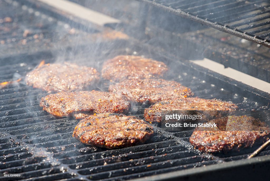 Hamburgers cooking on barbecue