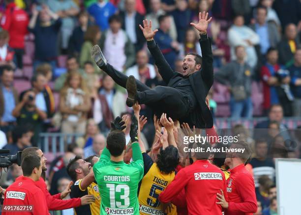 Diego Simeone the coach of Club Atletico de Madrid is thrown in the air by his players after winning the La Liga after the match between FC Barcelona...