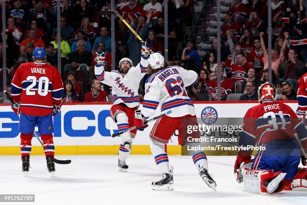 Martin St. Louis of the New York Rangers celebrates with Carl Hagelin after scoring a first period goal against the Montreal Canadiens in Game One of...