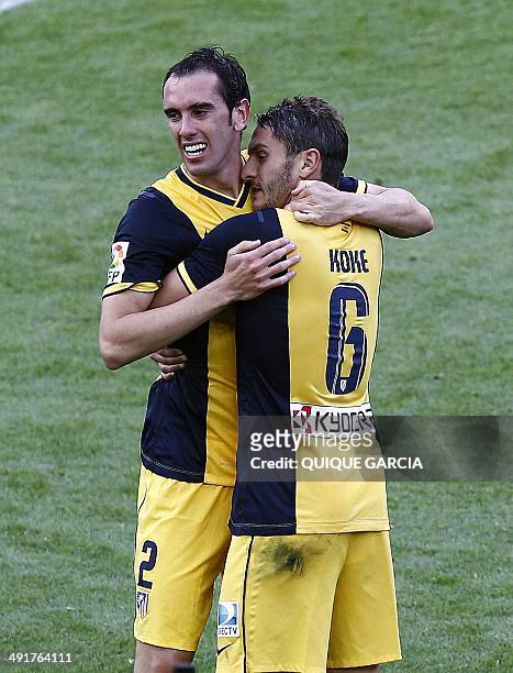 Atletico Madrid's Uruguayan defender Diego Godin and Atletico Madrid's midfielder Koke celebrate their Spanish league title at the end of the Spanish...