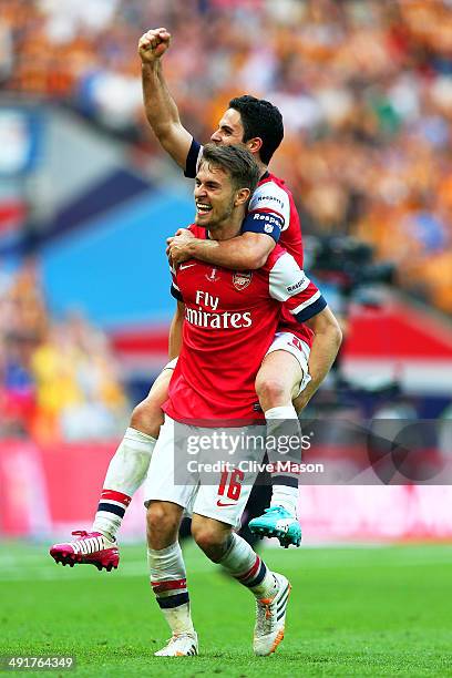 Aaron Ramsey and Mikel Arteta of Arsenal celebrate victory after the FA Cup with Budweiser Final match between Arsenal and Hull City at Wembley...