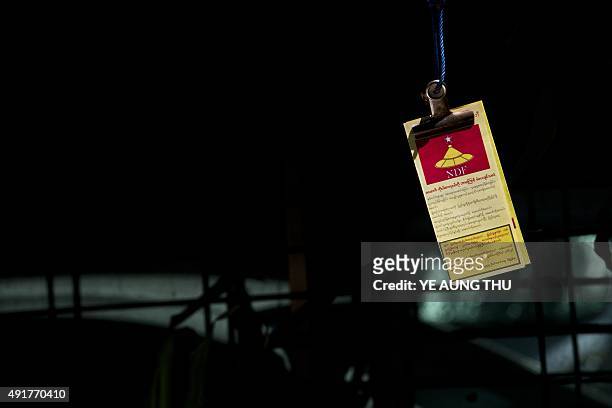 Flyers for the National Democratic Force party hang from a string, left by party members campaigning for the upcoming November 8 general election, in...
