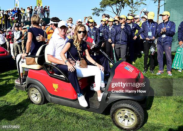 Jimmy Walker and Bubba Watson of the United States Team wait on a golf cart with their wives during the Thursday foursomes matches at The Presidents...