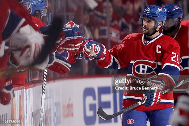Brian Gionta of the Montreal Canadiens celebrates with teammates after teammate Rene Bourque scores a second period goal against the New York Rangers...