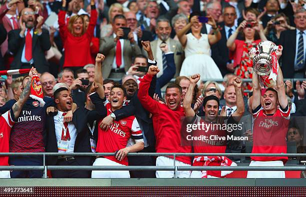 Captain Thomas Vermaelen of Arsenal lifts the trophy in celebration after the FA Cup with Budweiser Final match between Arsenal and Hull City at...