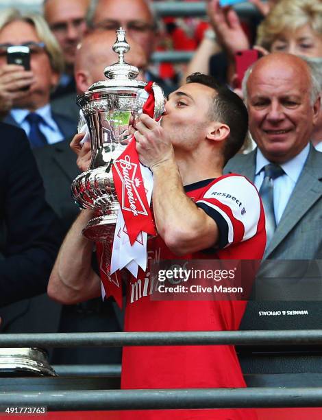 Captain Thomas Vermaelen of Arsenal kisses the trophy in celebration after the FA Cup with Budweiser Final match between Arsenal and Hull City at...