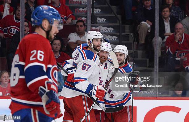 Brad Richards of the New York Rangers celebrates with teammates Benoit Pouliot and Daniel Carcillo after scoring a goal against the Montreal...