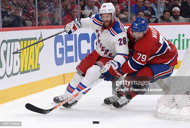 Andrei Markov of the Montreal Canadiens fights for the puck against Dominic Moore of the New York Rangers in Game One of the Eastern Conference Final...