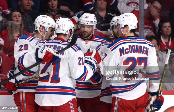 Chris Kreider of the New York Rangers celebrates with teammates Derek Stepan, Rick Nash and Ryan McDonagh after scoring a goal against the Montreal...