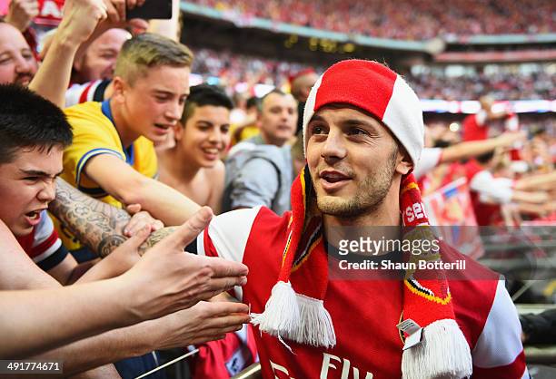 Jack Wilshere of Arsenal celebrates victory with fans after the FA Cup with Budweiser Final match between Arsenal and Hull City at Wembley Stadium on...