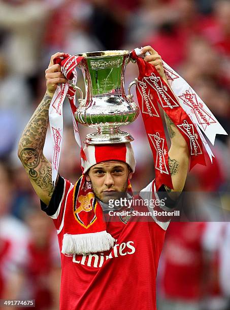 Jack Wilshere of Arsenal celebrates victory with the trophy after the FA Cup with Budweiser Final match between Arsenal and Hull City at Wembley...