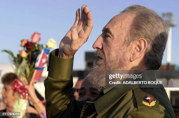 Cuban President Fidel Castro waves during the farewell ceremony to Nong Duc Manh, Vietnam's Communist Party Secretary General, 09 March 2004 at the...