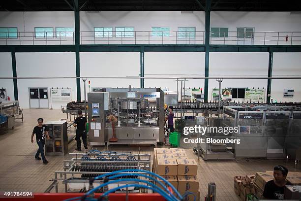 Employees work on the bottling line at the Myanmar Carlsberg Co. Plant in Nyaung Inn Village, Bago, Myanmar, on Wednesday, Oct. 7, 2015. Carlsberg...